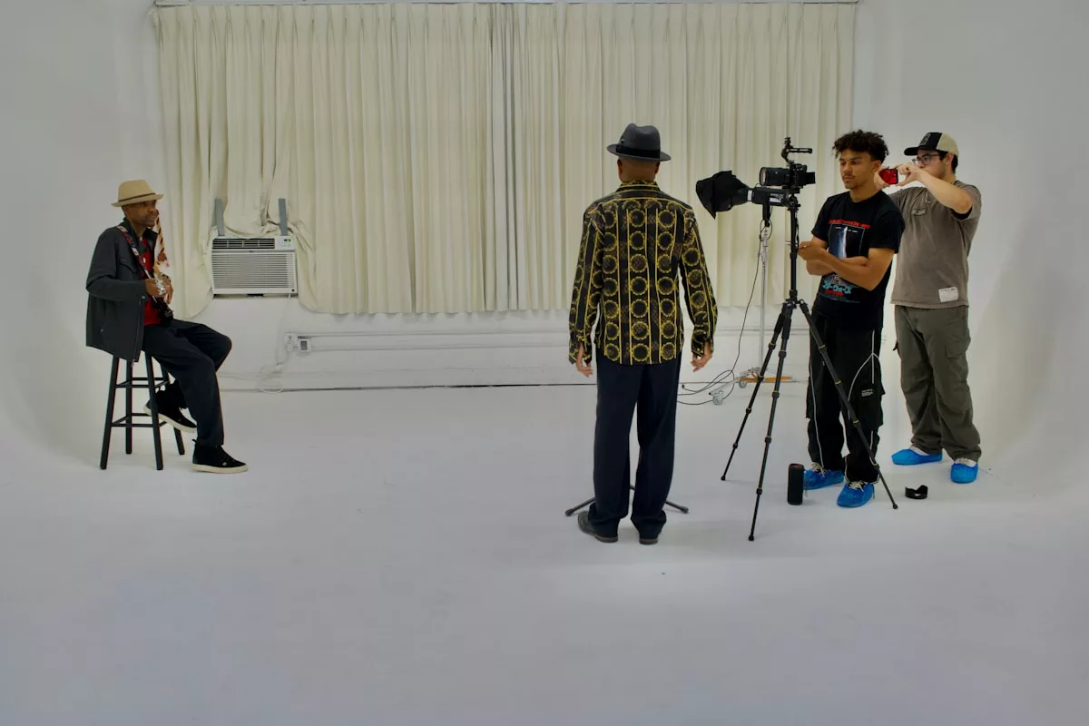 A group of people standing around a white room